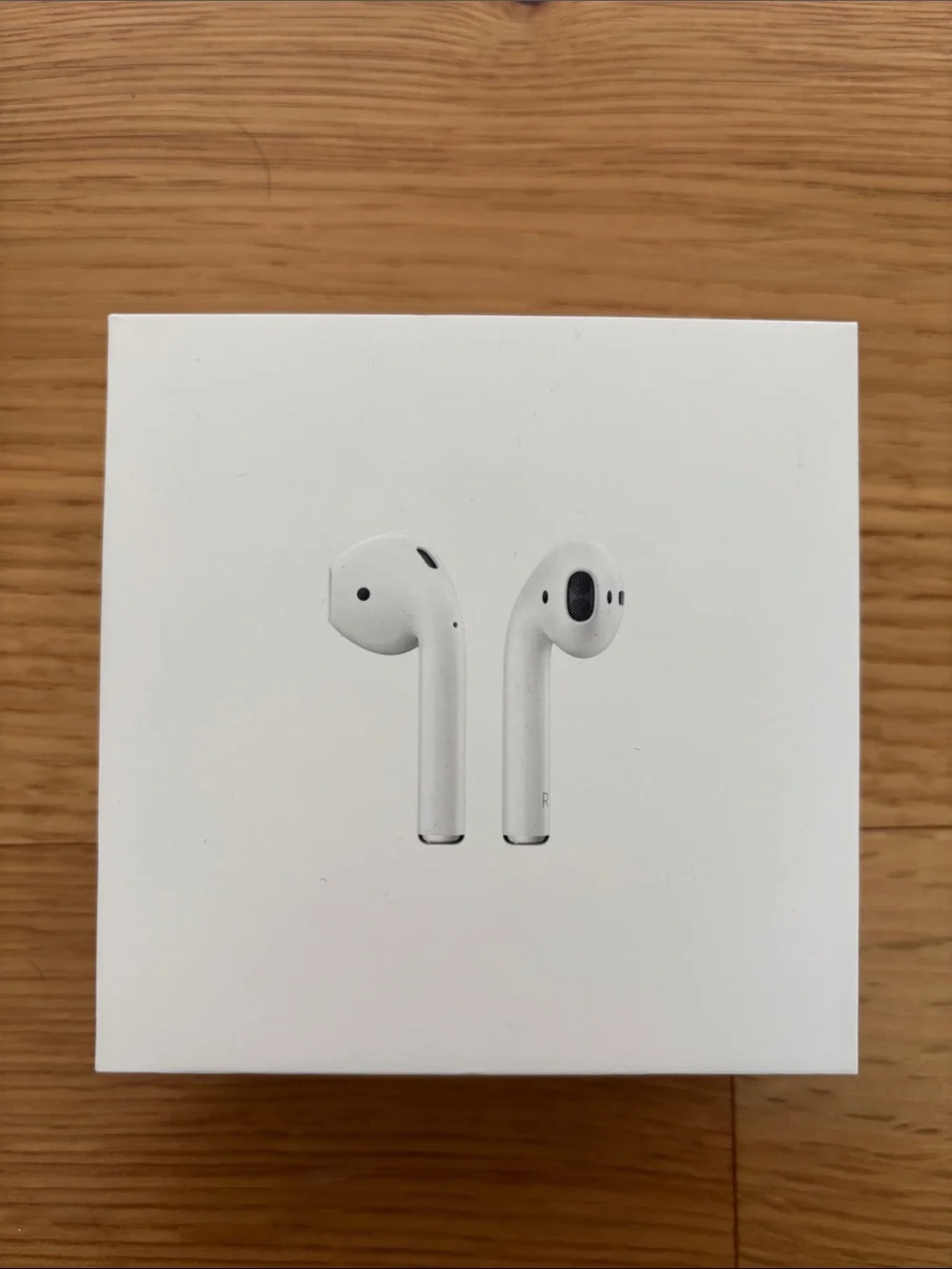 Apple AirPods (2nd gen) with charging case, charging cable, and ThredUp case